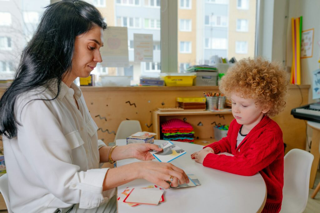 Boy on the session of speech therapist. Lesson on the development of speech in kindergarten. Teacher